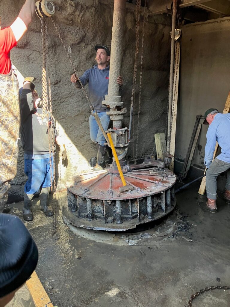 Image of turbine being removed and repaired at Bear's Mill